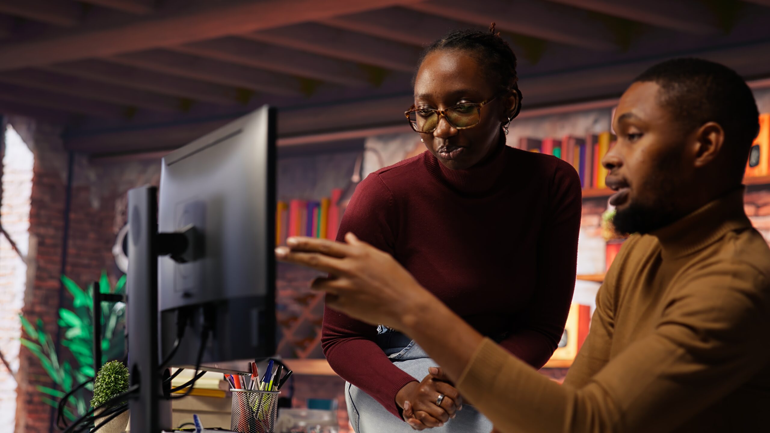 IT worker and colleague programming in AI startup office to build applications